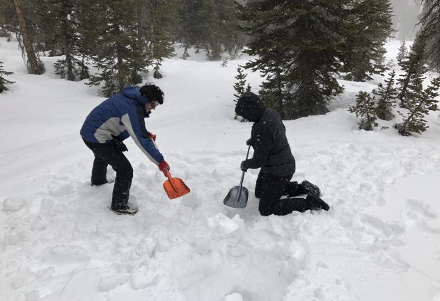 researchers shoveling in the snow